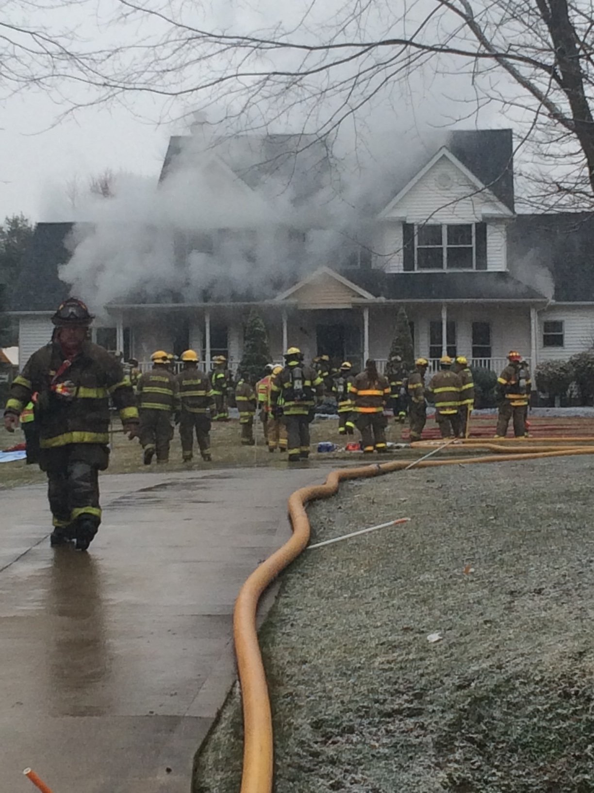 Firefighters responding to the 2016 house fire, smoke billowing from the home