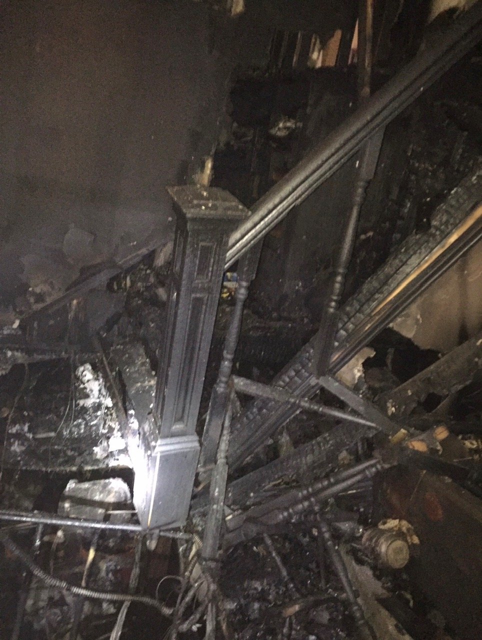 The same stairwell after the 2016 fire — charred and destroyed